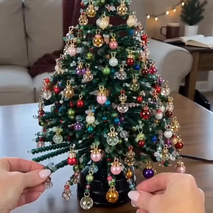 Hands adding an ornament to a beaded tree