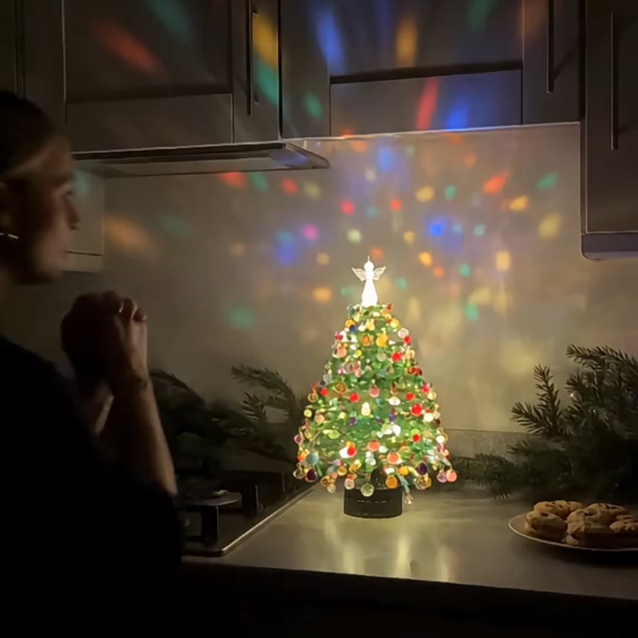 Beaded tree glowing in a dark kitchen